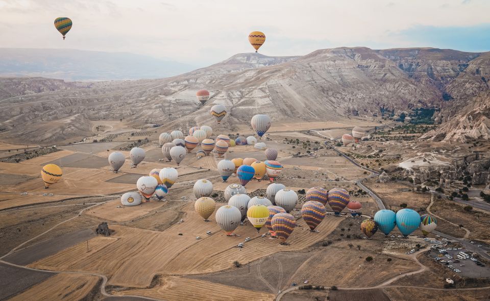 Hot air balloons in Goreme red valley - Sunrise over Cappadocia’s Red Valley